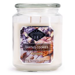 A large, round, white scented candle in a glass jar. The label on the jar reads "Santa's Cookies" and features a festive holiday design with purple and white flowers.