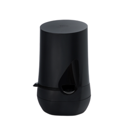 Black, cylindrical cream dispenser with a tear-drop shaped opening at the top.