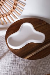 Asymmetrical white tray with a unique organic shape, made of wood, suitable for decorative purposes.