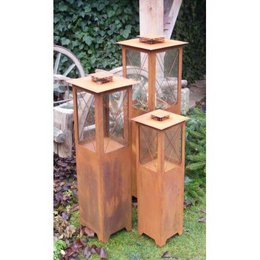 Patina metal lantern in various sizes, featuring a rustic, weathered finish and glass panels for a warm, ambient glow. Suitable for outdoor garden decor.