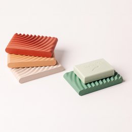 Wavy soap holder in terracotta, off-white, red, and green colors. Unique wave-like design provides functional and decorative storage for soap bars.