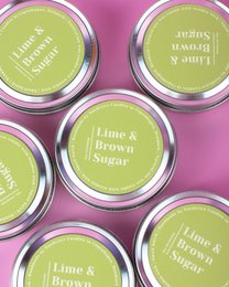 Medium scented soy candles in lime and brown sugar fragrance. Round, tall candle jars with green labels.