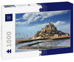A 1000-piece puzzle depicting the iconic Mont Saint-Michel in France, a medieval abbey and village situated on a rocky island. The image shows the historic structure surrounded by water and a cloudy blue sky.