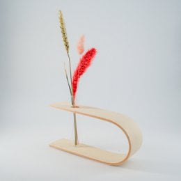 Decorative wooden vase with abstract floral accent in various color options.