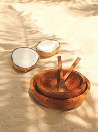 Handcrafted palm wood bowl in small and large sizes, featuring a natural, rustic design with a smooth, rounded shape.