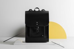 A stylish, durable backpack made of high-quality black fabric with a simple, minimalist design.