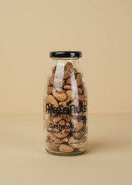 Oven roasted sea salt cashews in a glass bottle, 140g content.