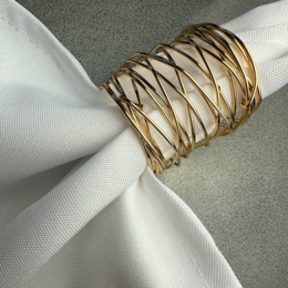 Gold-colored napkin ring with a woven, lattice-like pattern.