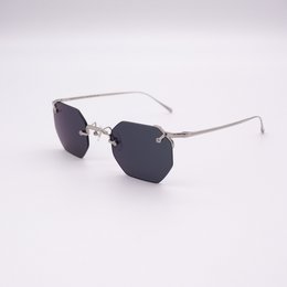 Sleek, modern black panther-inspired sunglasses with a hexagonal frame and silver metal accents.