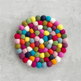 Round, white and gray coaster with a textured, patterned design.