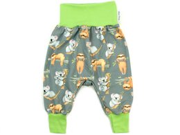 Baby pants in a unisex design featuring koalas and sloths in grey and lemon colors. The pants have a comfortable elastic waistband and are available in sizes 50/56, 62/68, 74/80, 86/92, and 98/104.