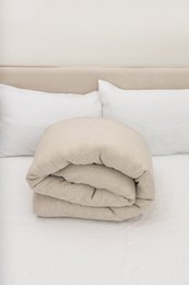  Natural linen duvet cover in various sizes, featuring a soft, neutral color and natural material for a cozy, minimalist bedroom style.