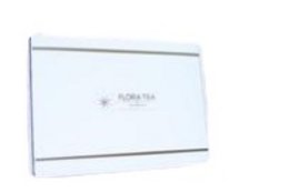 A white gift box with the text "Flora Tea Royal Gift Box" printed on it, containing several white tea bags or tea cubes arranged neatly inside.