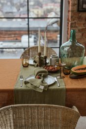 Olive green linen table runner, available in 40x150 cm, 40x200 cm, and 38x100 cm sizes. Made of high-quality linen material, this runner features a natural, earthy tone that complements a variety of table settings.