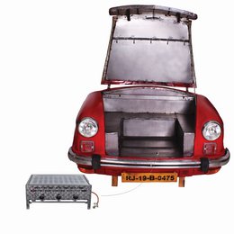 A red vintage car with a rear-mounted engine and a distinctive rounded shape. The car appears to be a classic Volkswagen Beetle or similar model.