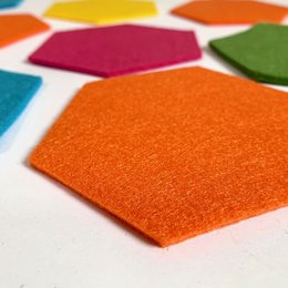Set of 4 hexagon-shaped felt coasters in a variety of vibrant colors including orange, blue, green, and gray.