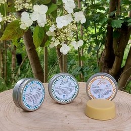 A round tin deodorant bar in various scents including grapefruit, lavender, sandalwood-bergamot, spa spheres, and perfectly pure (no perfume). The deodorant bar is made of natural ingredients and comes in a reusable tin.
