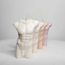 Vegan soy wax candle in the shape of a male torso, available in various neutral colors including cream, peach, pearl, stone, fawn, caramel, cocoa, ebony, and dove. The candle has a minimalist, sculptural design that would make an elegant home decor accent.
