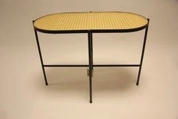 Oval coffee table with black metal frame and yellow webbing top. Suitable for living room or office.