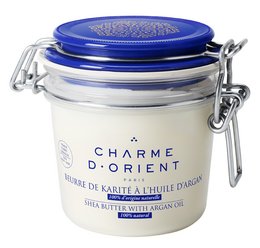 Shea butter body lotion in various scents including neutral, amber, fruit, floral, vanilla, oriental, green tea, and more. Packaged in a glass jar with a blue lid.