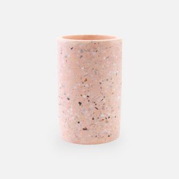  Blush-colored terrazzo vase with a cylindrical shape and a textured surface.