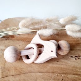 Wooden rattle with rings in the shape of a bird, designed for babies. Features soft, fuzzy textures and a natural, organic design.