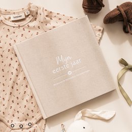  Beige linen baby book for a baby's first year, with milestones and memories to record.