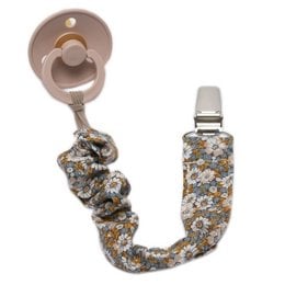Pacifier holder with a boho-inspired floral design in sage green color, featuring a flexible cord to attach to clothing or stroller.