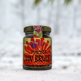 Organic mulled wine blend in a glass jar with a vibrant, colorful label featuring a sun-like design.