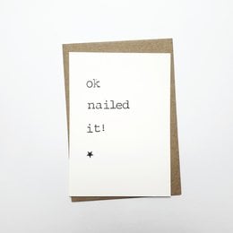 A greeting card with the text "Ok nailed it!" printed on a white background.