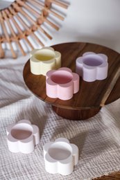  Flower-shaped tea light holders in white, beige, yellow, pink, and lavender colors. Ceramic candle holders with a floral design.