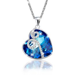 Blue heart-shaped pendant necklace with silver-tone chain and decorative elements.
