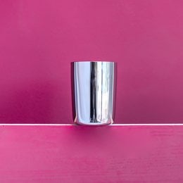 Amrapali glass, a cylindrical glass container with a smooth, shiny surface.