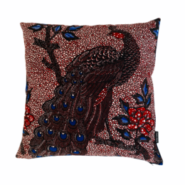 A decorative cushion featuring a vibrant peacock design in shades of red, blue, and gold. The cushion has a textured, embroidered pattern that adds depth and visual interest. The cushion measures 50x50 cm and is suitable for use in living rooms, bedrooms, or other home decor settings.