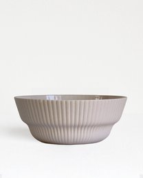  Sand colored ceramic bowl with vertical ribbed column texture, wide shallow shape, minimalist design
