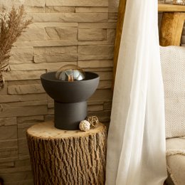 Modern black table lamp with a round, dome-shaped shade and a cylindrical base. The lamp is designed for use on a table or other flat surface.