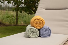  Plaid throw blanket in taupe color, made of soft, cozy material. Available in various colors including black, golden yellow, ivory, nova blue, pink, sand, sea green, and taupe.