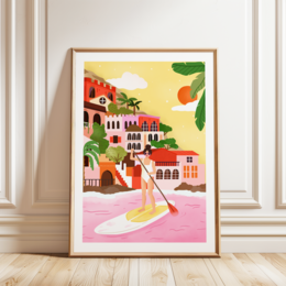  A vibrant, colorful illustration depicting a girl paddle boarding in a scenic coastal town with Mediterranean-style architecture, palm trees, and a bright sun in the sky.