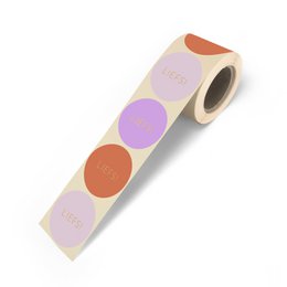 A roll of colorful stickers in various shades of orange, purple, and pink. The stickers appear to be circular in shape and have the word "Liefs" printed on them.