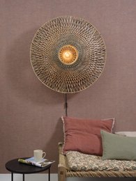 A large, round wall lamp with a woven, sunburst-like design in natural and black colors. The lamp has a warm, glowing light in the center.