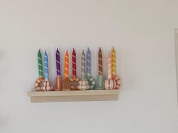 Colorful, striped candles in various pastel shades including pink, yellow, and red. The candles appear to be part of a "Twister Collection" and are suitable for use as dinner candles.