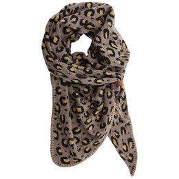  Soft, warm gray scarf with a leopard print pattern. Made of a cozy, lightweight material that can be worn as an accessory to add a touch of style to any outfit.
