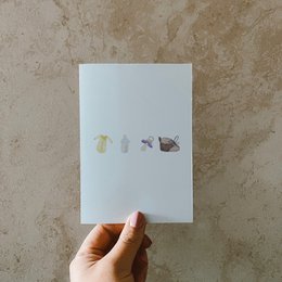 Postcard with baby accessories icons, made of recycled paper.