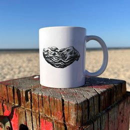 A white ceramic mug featuring a detailed illustration of a starfish against a blue background, surrounded by seashells and other beach elements.