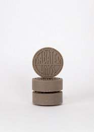 A rectangular bar of brown patchouli soap, approximately 100g in size, with a round embossed logo on the top.