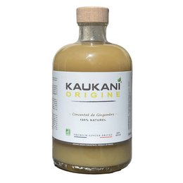 Kaukani Origine 700ml, a natural mocktail with a clear glass bottle and wooden cap, featuring a light yellow liquid and a mint leaf garnish.