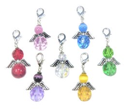 Set of 7 colorful angel-shaped keychains with various gemstone accents. Includes angels in red, pink, purple, blue, green, yellow, and clear crystals. Decorative and functional accessory.