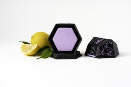  Solid shampoo bar for dry, damaged, or weak hair. Made with natural ingredients like pine needles and herbs. Hexagonal shape with embossed logo.