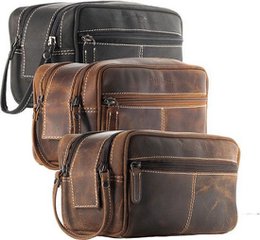 Leather toiletry bag with multiple compartments, suitable for men or women. Made of high-quality brown leather material with a durable and stylish design.