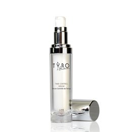 Time Control Serum, a toner product with a sleek, cylindrical glass bottle and silver cap. The serum is designed to help control the appearance of time on the skin.